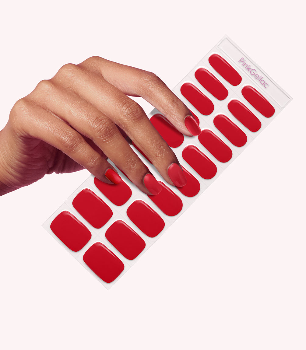 Hand wearing Pink Gellac 034 Rocking Red gel nail stickers.