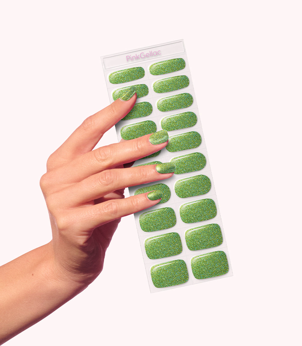 Hand wearing Pink Gellac 035 Sparkling Green gel nail stickers.