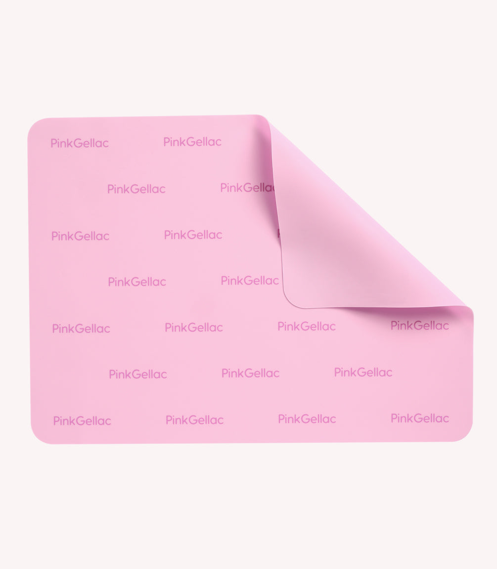 Pink play mat with the print "Pink Gellac" and a folded corner.