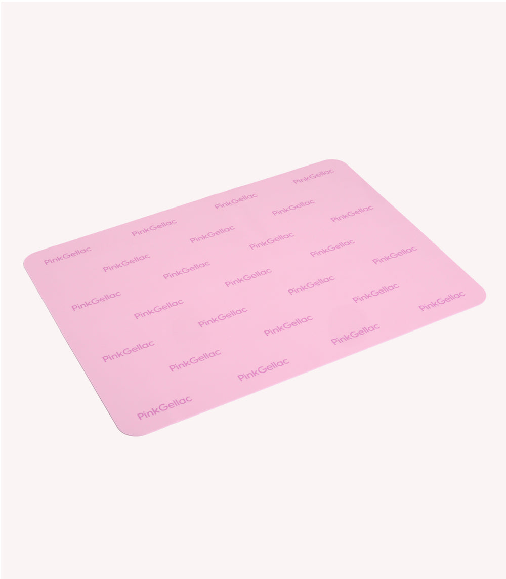 Pink silicone mat with repeated "PinkGellac" logo printed on it.