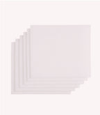 Six white napkins lie on top of each other on a white background.