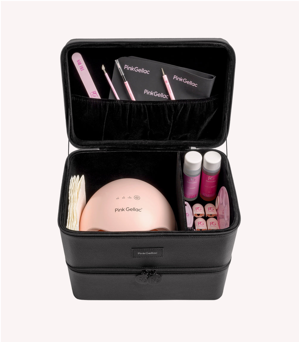 An open black case with nail care products from Pink Gellac inside, including a pink UV lamp, nail files, tools, bottles of liquid and jars of gel nail polish.