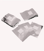 Four stacks of smooth aluminum foil sheets, each with a white square of foam in the middle, on a light background.