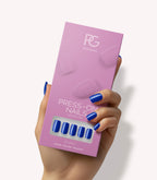 Hand holding Pink Gellac 221 Delighted Blue press-on nails in their packaging.