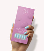 Hand holding Pink Gellac 266 Baby Blue press-on nails in their packaging.