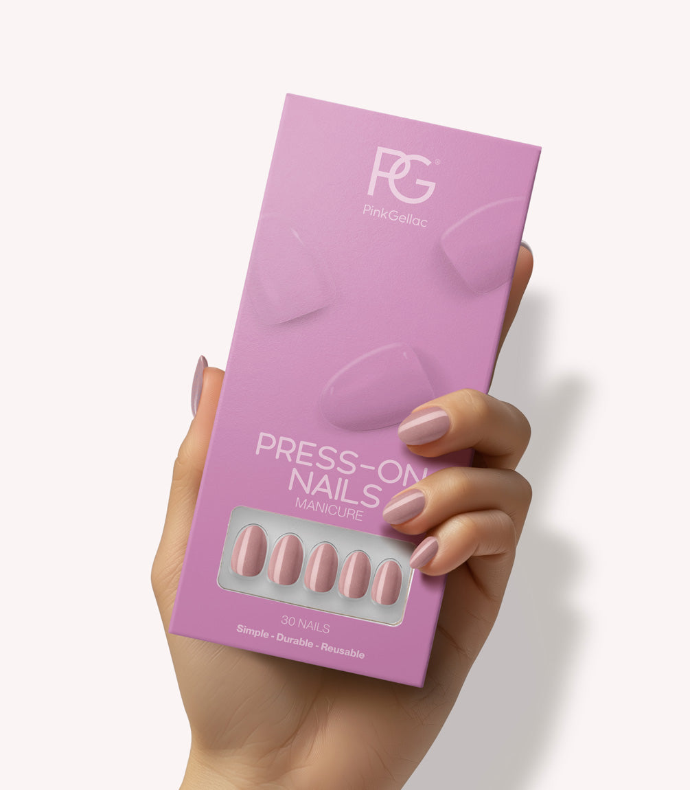 Hand holding Pink Gellac 305 Pearly Nude press-on nails in their packaging.