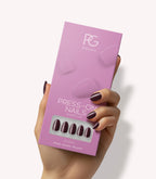 Hand holding Pink Gellac 332 Sangria Red press-on nails in their packaging.