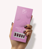 Hand holding Pink Gellac 332 Sangria Red press-on nails in their packaging.