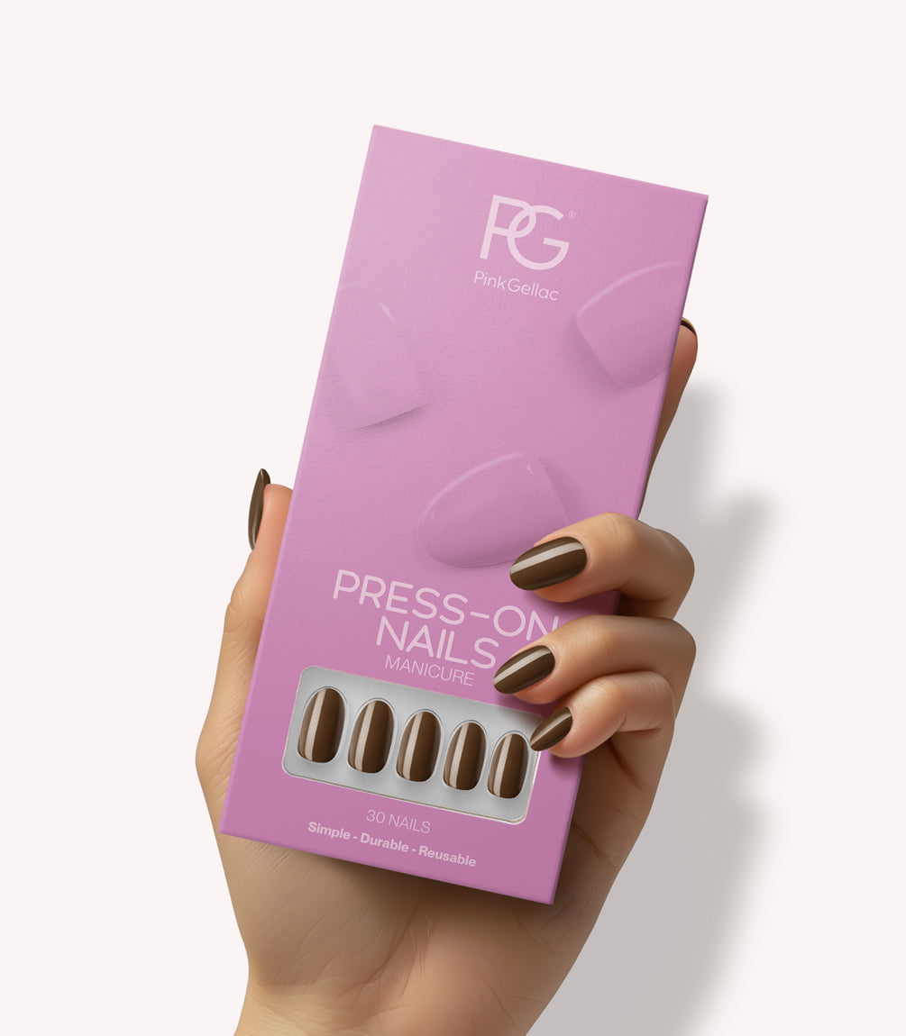 Hand holding Pink Gellac 421 Mocha Brown press-on nails in their packaging.