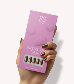 Hand holding Pink Gellac 421 Mocha Brown press-on nails in their packaging.