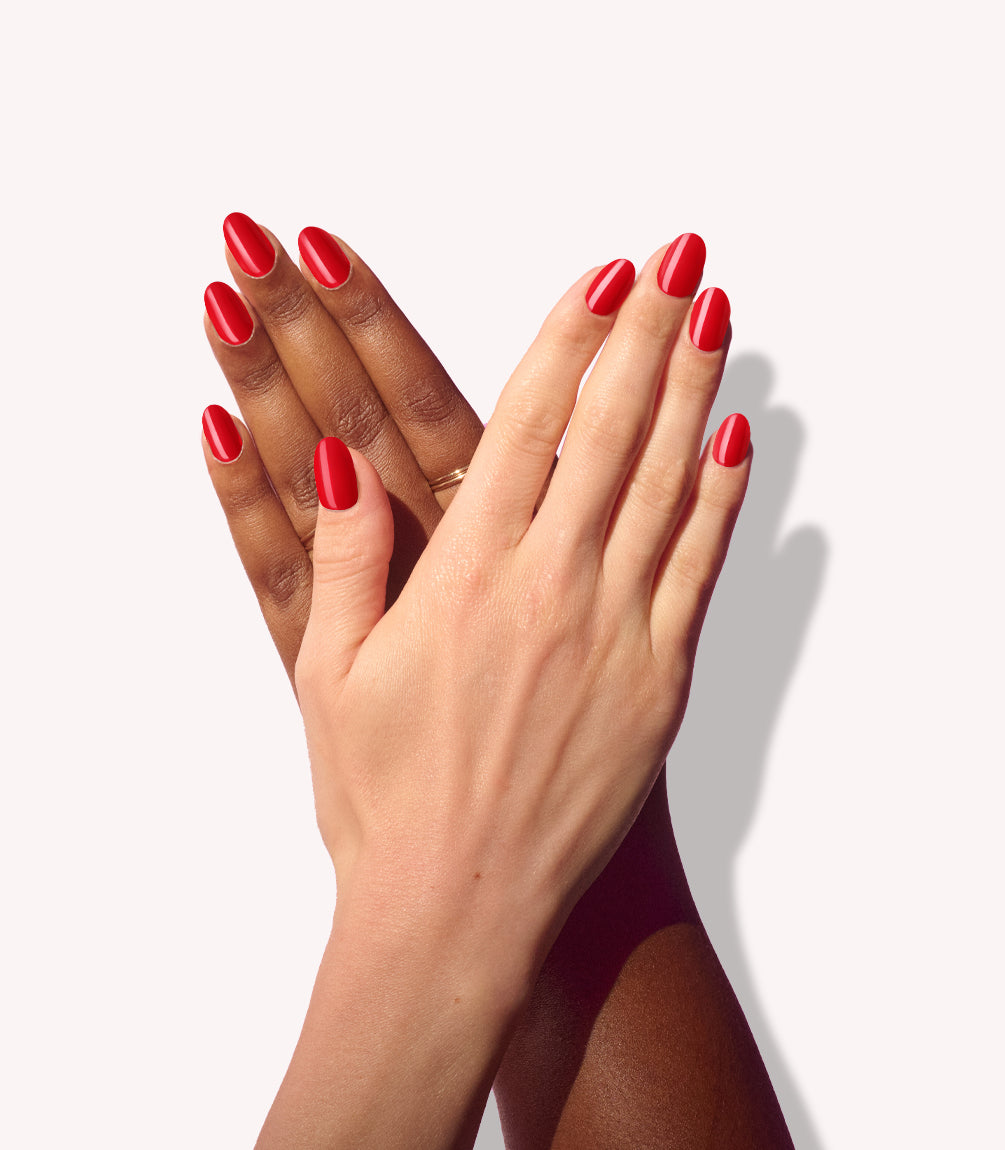 Two hands wearing Pink Gellac 430 Bombshell Red press-on nails.