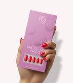 Hand holding Pink Gellac 430 Bombshell Red press-on nails in their packaging.