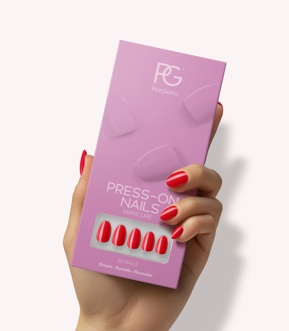 Hand holding Pink Gellac 430 Bombshell Red press-on nails in their packaging.
