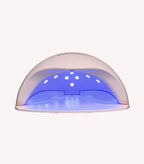 A white UV lamp for nails with blue light on the inside.