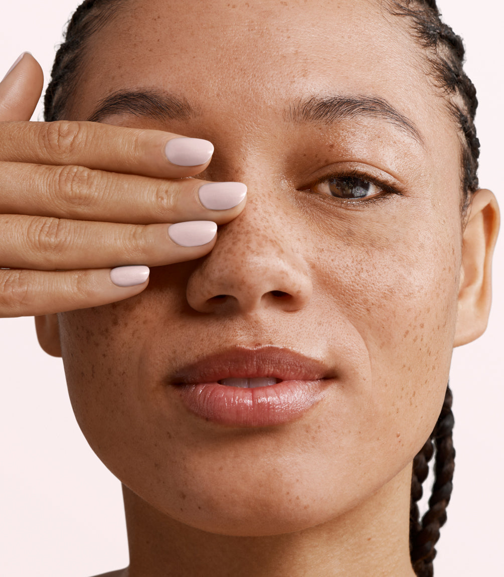 Close-up of a woman with Pink Gellac 418 Meringue Pink manicured nails near her face.