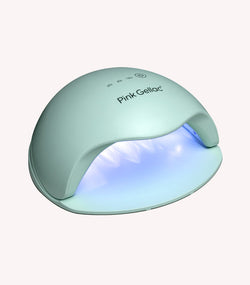 Mint green LED nail lamp with brand name "Pink Gellac" on the top and a soft blue glow on the inside.