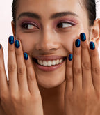 Close-up of a woman with Pink Gellac Cat Eye Ethereal Topaz manicured nails near her face.
