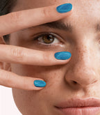 Close-up of a woman with Pink Gellac Cat Eye Luminous Nebula manicured nails near her face.