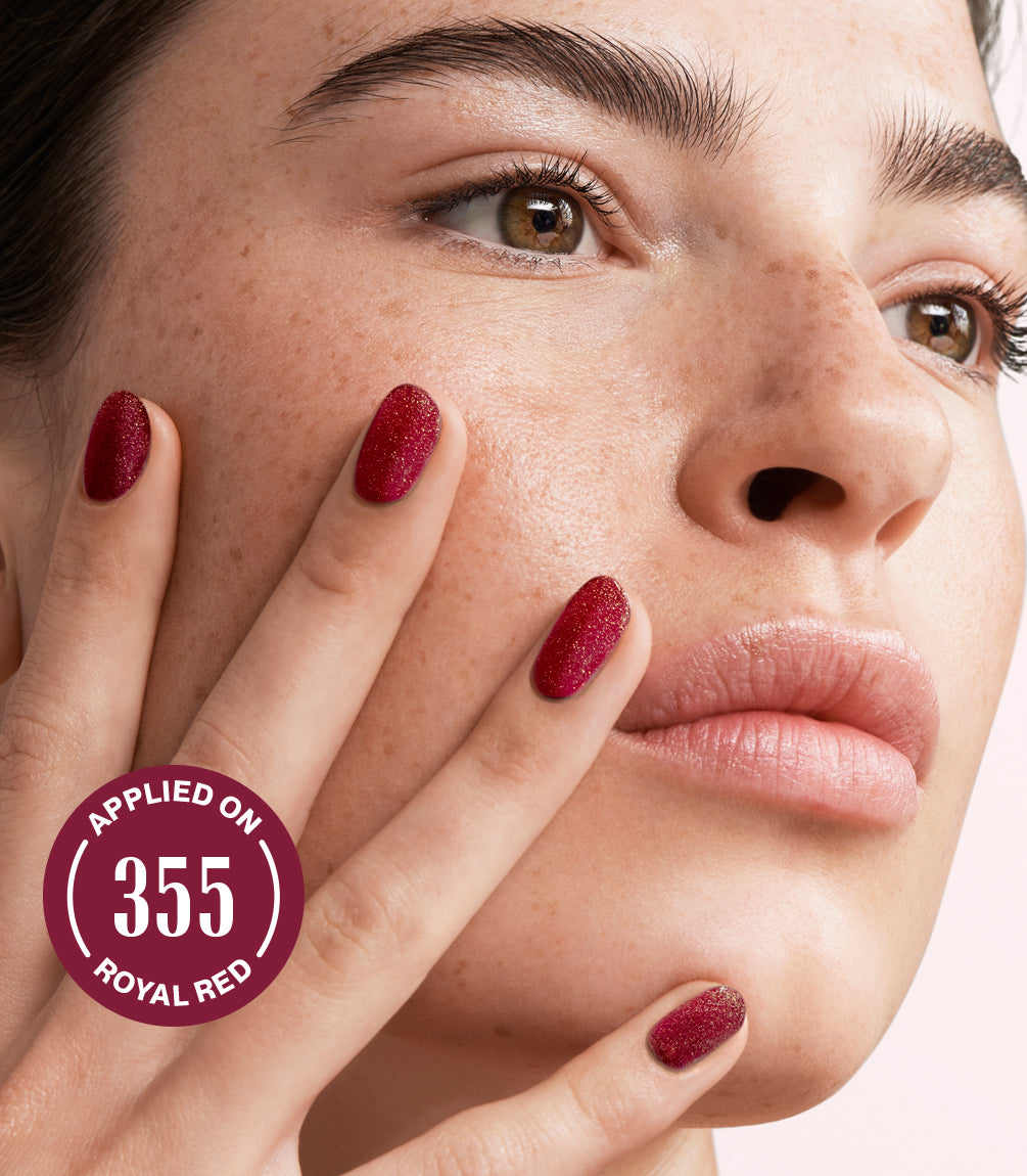 Close-up of a woman with Pink Gellac Effect Coat Gold Glitter manicured nails near her face.