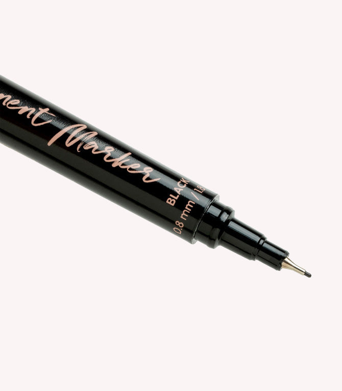 Close-up of a black fineliner marker pen with a narrow 0.8 mm tip.