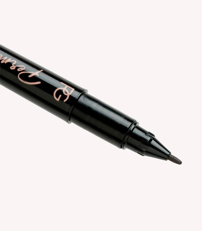 Close-up of a black felt-tip pen with a sharp point.