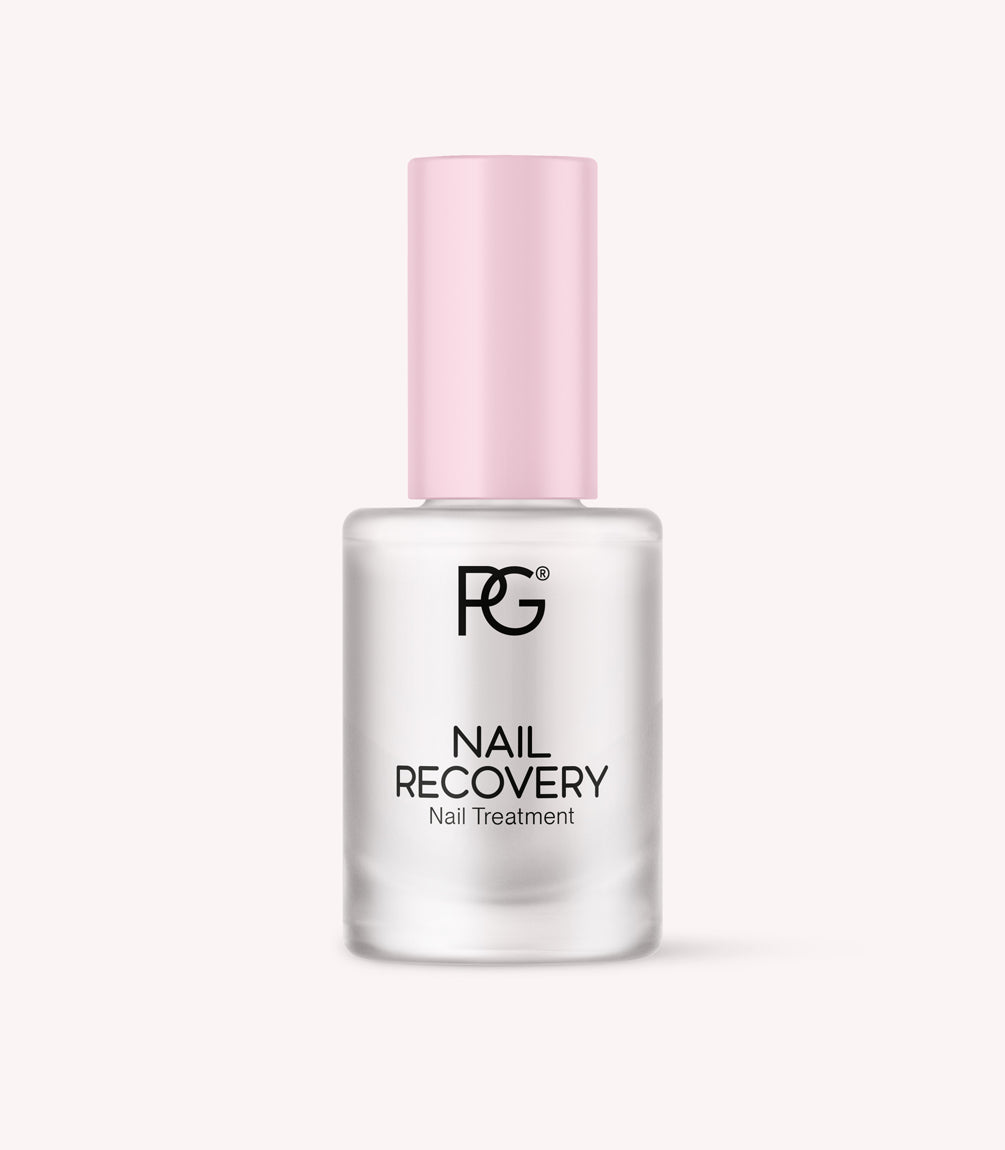 Bottle of nail restorer with pink cap and black inscription "Nail Recovery Nail Treatment".
