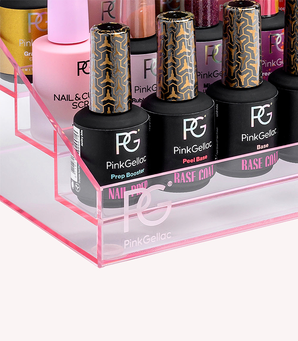 A pink acrylic stand with several bottles of Pink Gellac nail polish and care products.